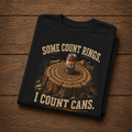 Camping Humor T-Shirt — “Some Count Rings, I Count Cans” Beer Can Tree Stump Tee