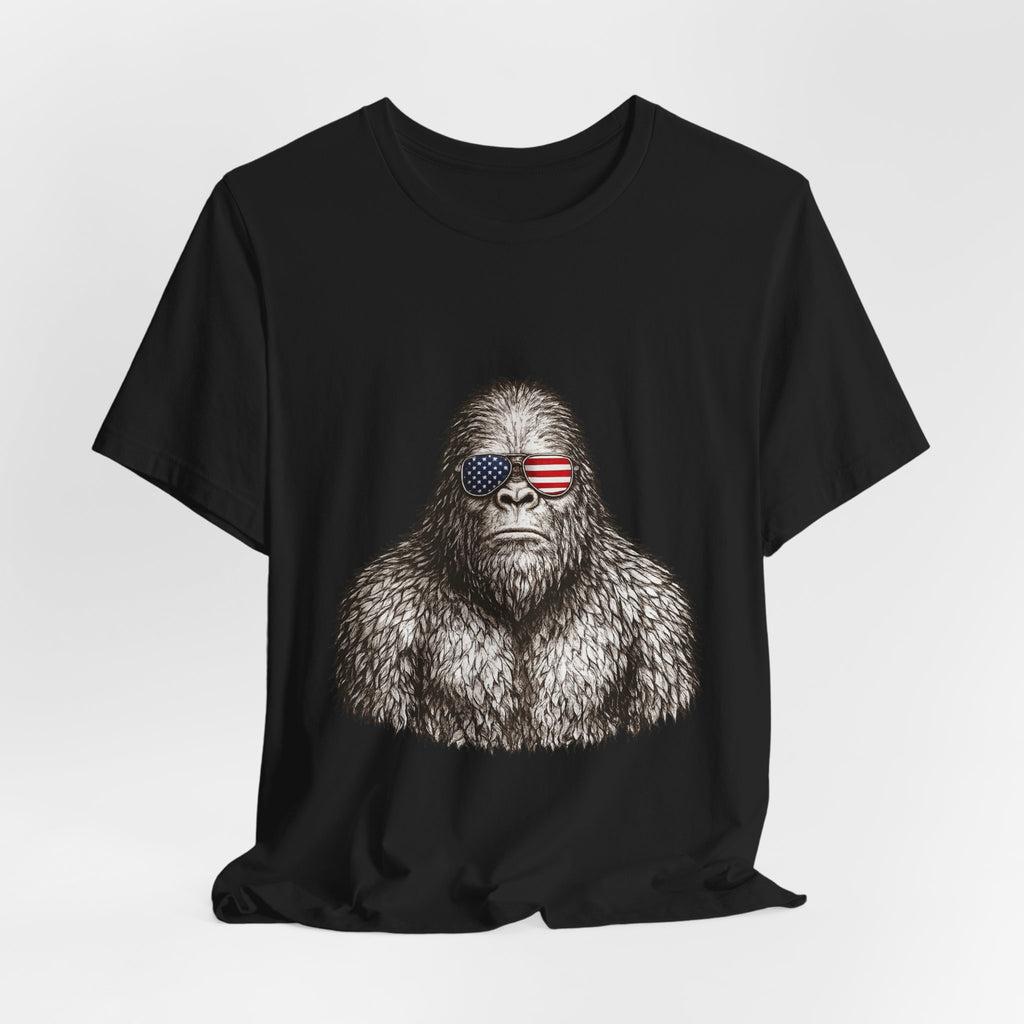 Patriotic Sasquatch Tee — Bigfoot Wearing American Flag Sunglasses